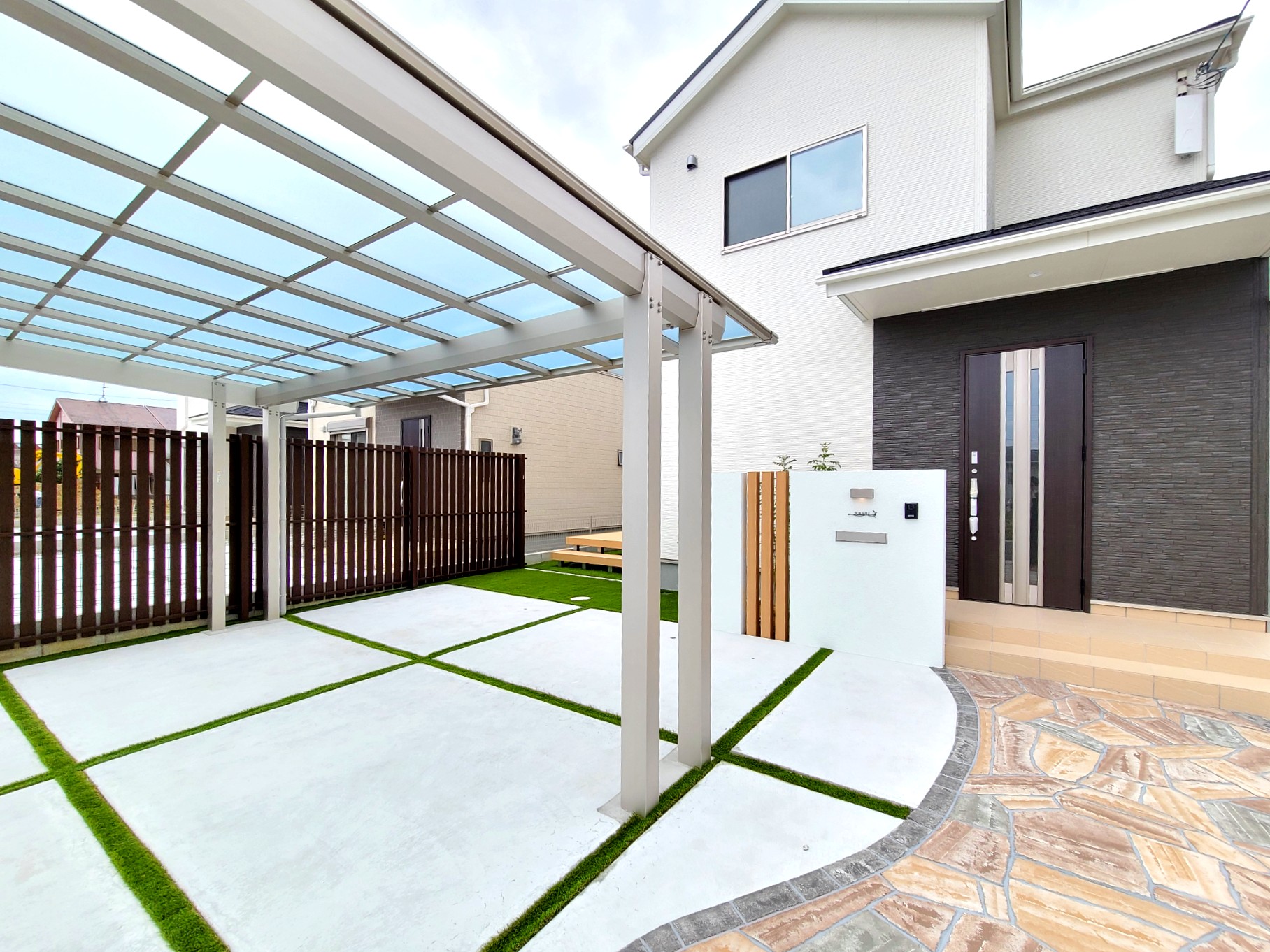 後方支持のカーポートで駐車しやすく、人工芝で緑を入れて外構を彩っています。

 